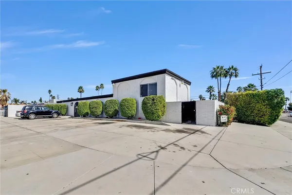 a view of a house with palm trees