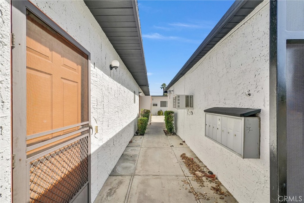 1900 East Baristo Road Palm Springs, CA 92262 - Photo 7 of 23 a view of a hallway with washer and dryer