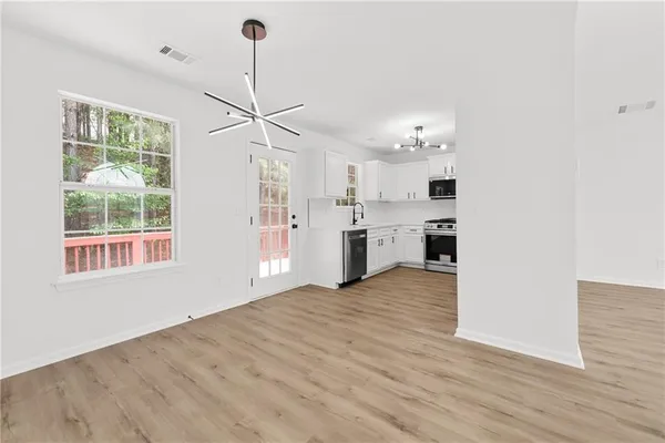 a view of a kitchen with a stove cabinets and wooden floor