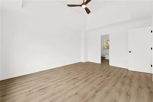 a view of empty room with wooden floor