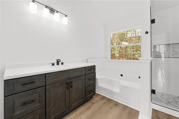 a bathroom with a bathtub and a shower