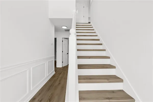 a view of entryway and hall with wooden floor