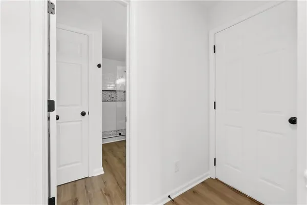 a view of an entryway with wooden floor