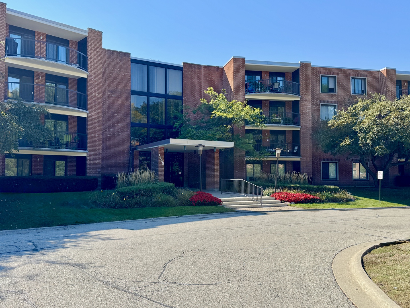 a front view of building with yard