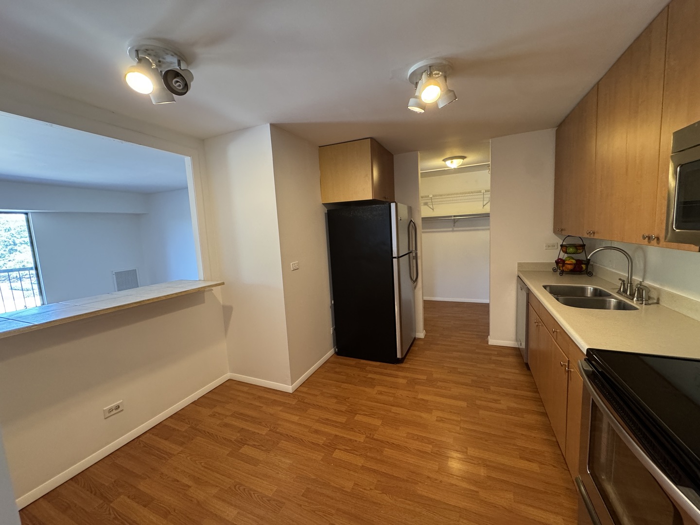1415 East Central Road, Unit 301A Arlington Heights, IL 60005 - Photo 5 of 11 a kitchen with a sink and refrigerator
