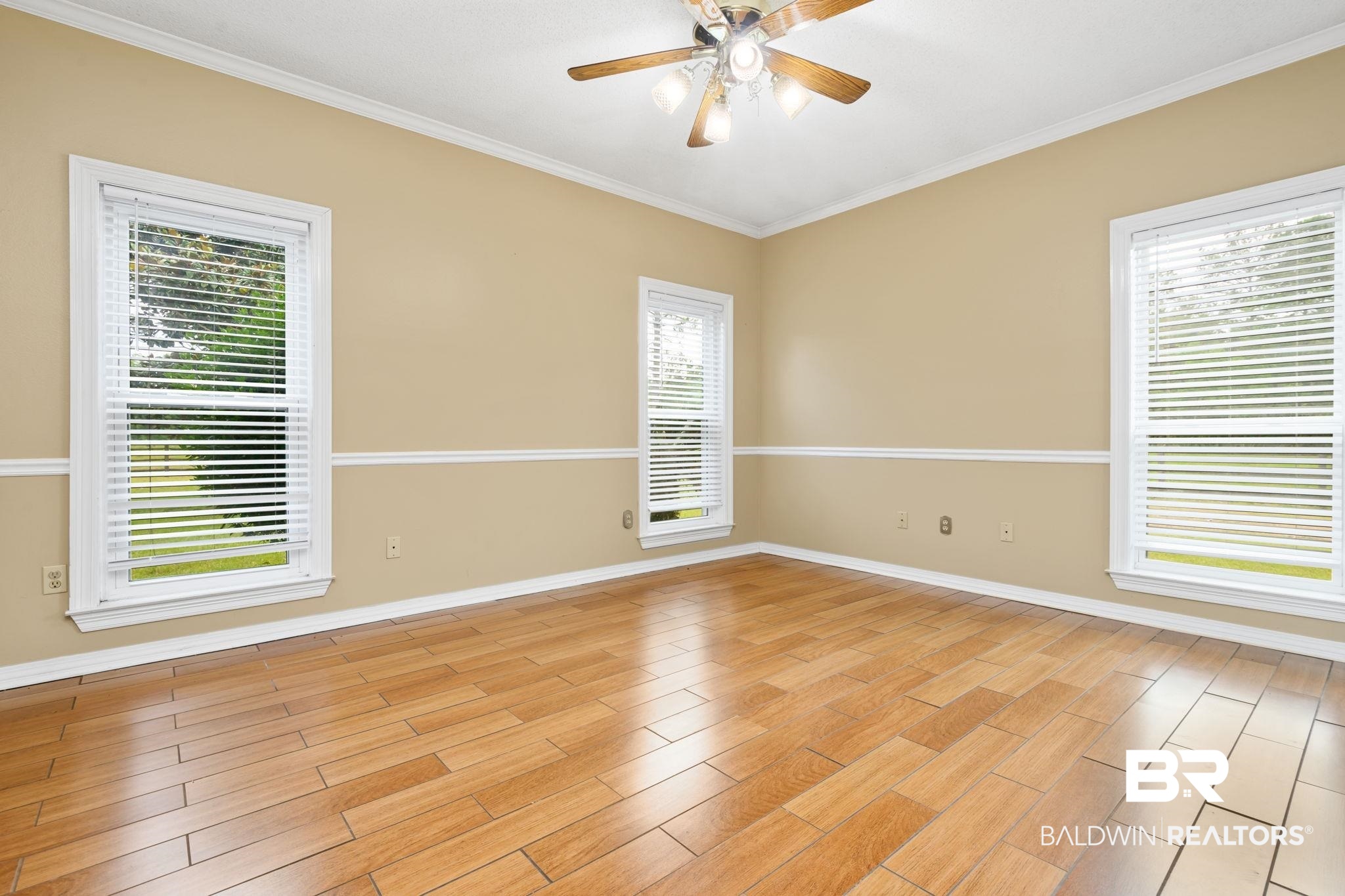 7540 2 Mile Road Irvington, AL 36544 - Photo 48 of 82 Spacious interior room featuring wood-finish flooring, neutral wall tones, and white crown molding