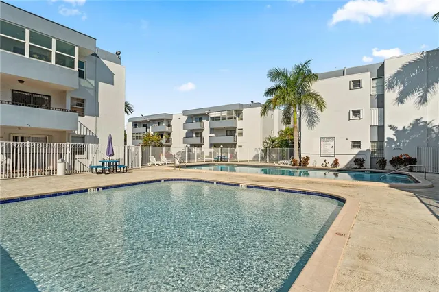 a swimming pool with outdoor seating and yard
