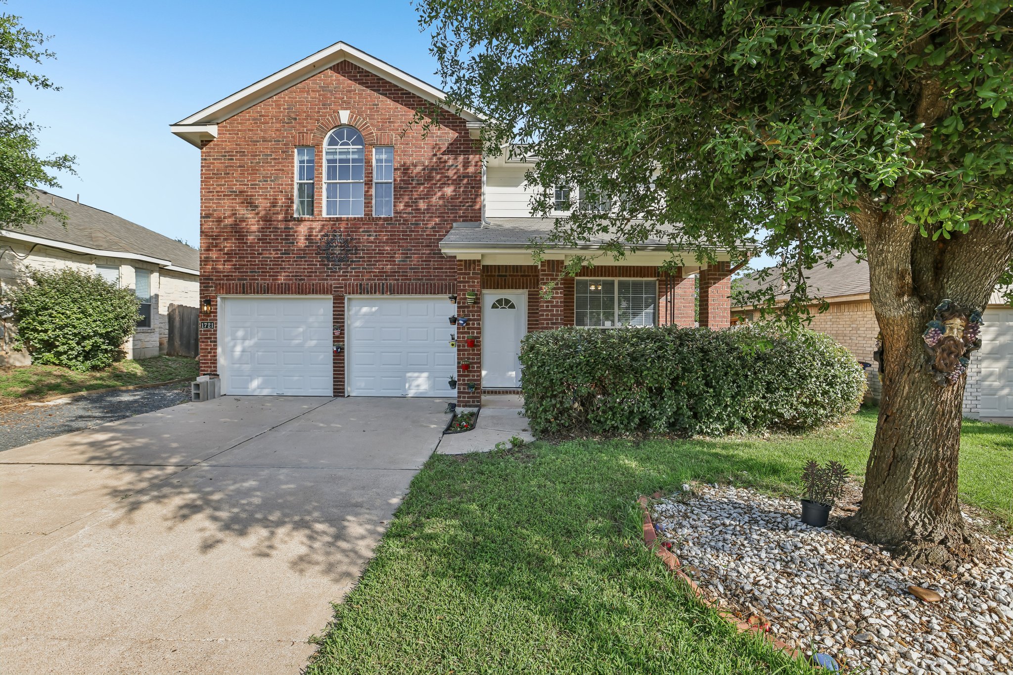 1721 Long Rifle Drive Austin, TX 78754 - Photo 1 of 38 A classic brick exterior with an arched window and covered entryway creates inviting curb appeal.