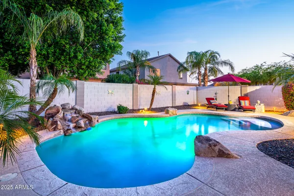 an aerial view of a house with swimming pool and porch