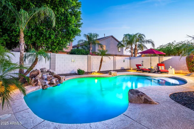 an aerial view of a house with swimming pool and porch