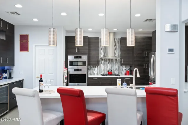 a living room with furniture a ceiling fan and a wooden floor