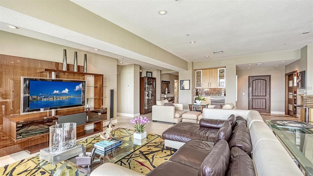 650 Golden Gate Point, Unit 602 Sarasota, FL 34236 - Photo 11 of 50 a living room with furniture and a flat screen tv