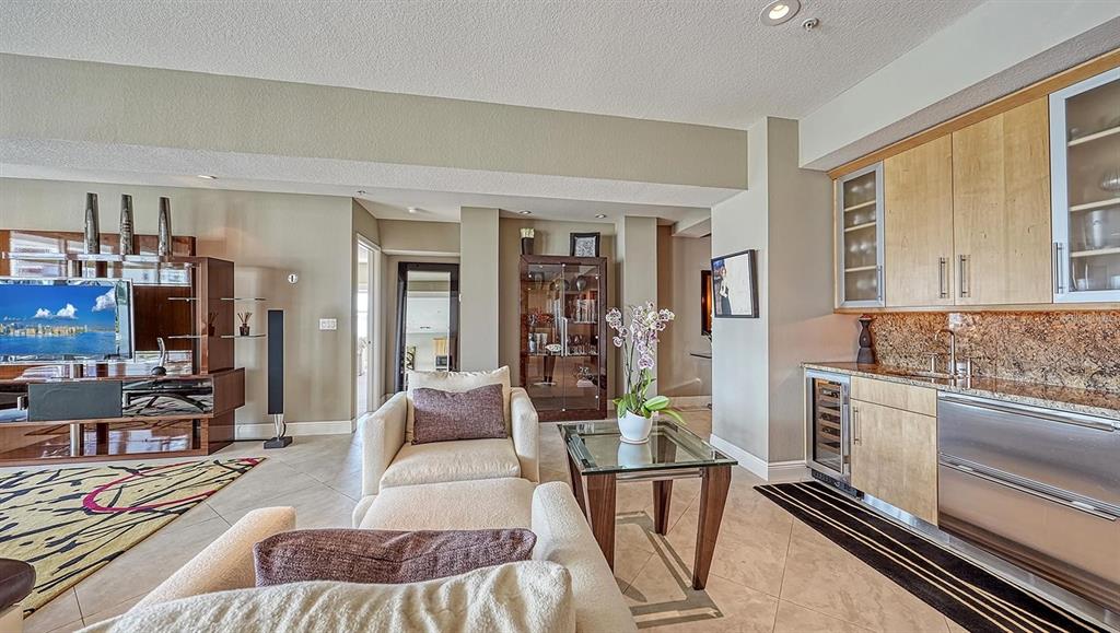 650 Golden Gate Point, Unit 602 Sarasota, FL 34236 - Photo 14 of 50 a living room with furniture and a flat screen tv
