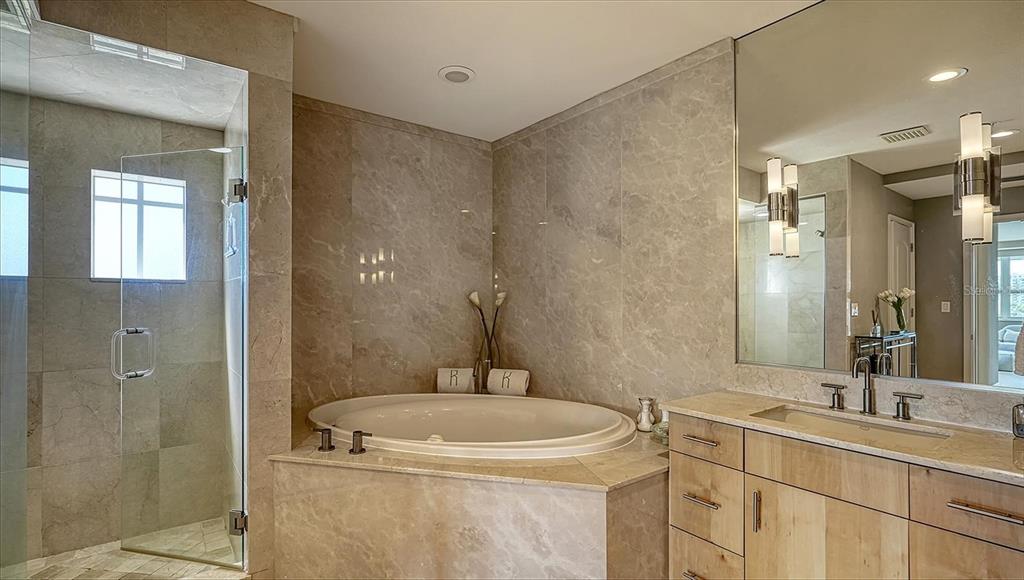 650 Golden Gate Point, Unit 602 Sarasota, FL 34236 - Photo 27 of 50 a bathroom with a sink a toilet and shower
