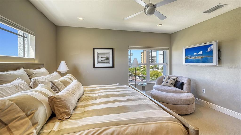 650 Golden Gate Point, Unit 602 Sarasota, FL 34236 - Photo 36 of 50 a bedroom with a bed and ceiling window