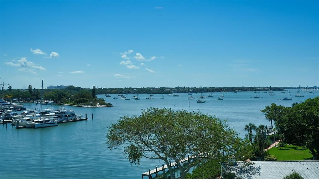 650 Golden Gate Point, Unit 602 Sarasota, FL 34236 - Photo 41 of 50 a view of ocean with boats and trees in the background