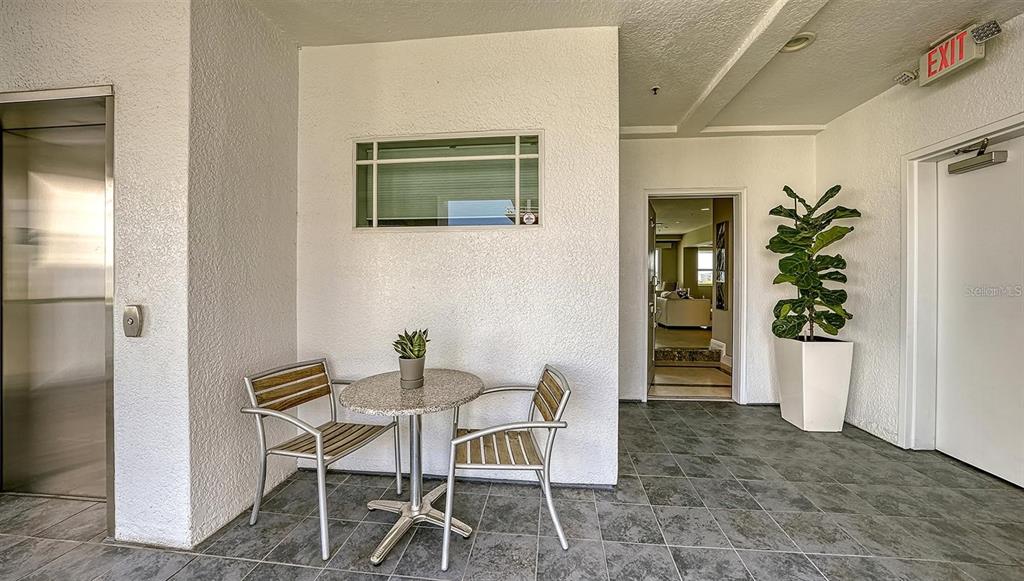 650 Golden Gate Point, Unit 602 Sarasota, FL 34236 - Photo 45 of 50 a view of a dining room with furniture and front door