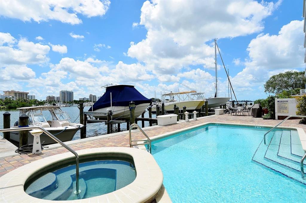 650 Golden Gate Point, Unit 602 Sarasota, FL 34236 - Photo 49 of 50 a swimming pool with outdoor seating and barbeque