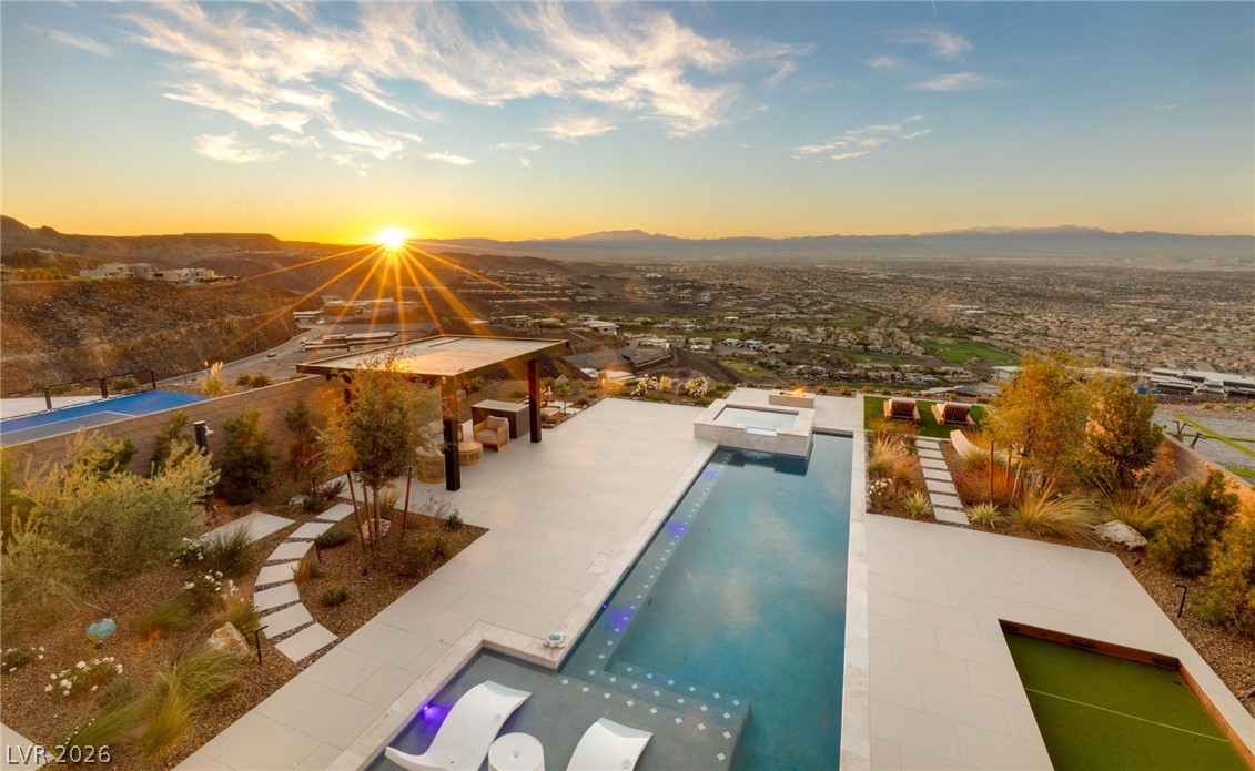 571 Overlook Rim Drive Henderson, NV 89012 - Photo 56 of 85 Pool at dusk featuring an outdoor pool and a mountain view