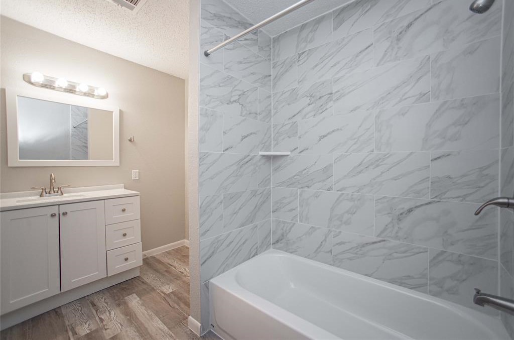 317 Pear Street La Marque, TX 77568 - Photo 13 of 18 a bathroom with a sink and a bathtub