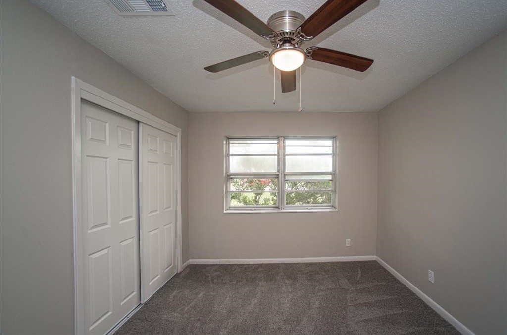317 Pear Street La Marque, TX 77568 - Photo 14 of 18 an empty room with windows and fan