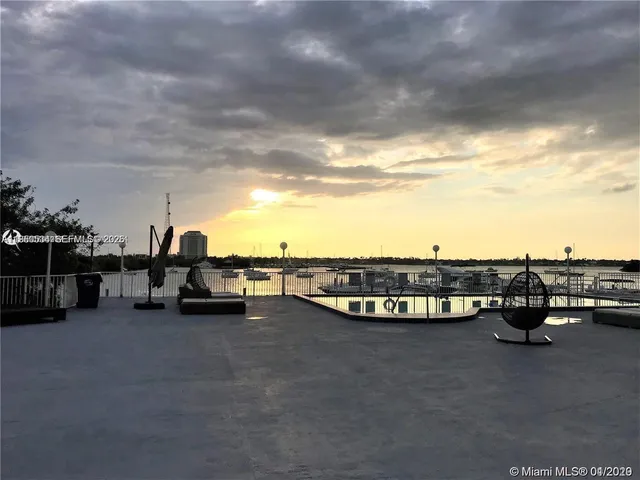 a view of a terrace with lawn chairs
