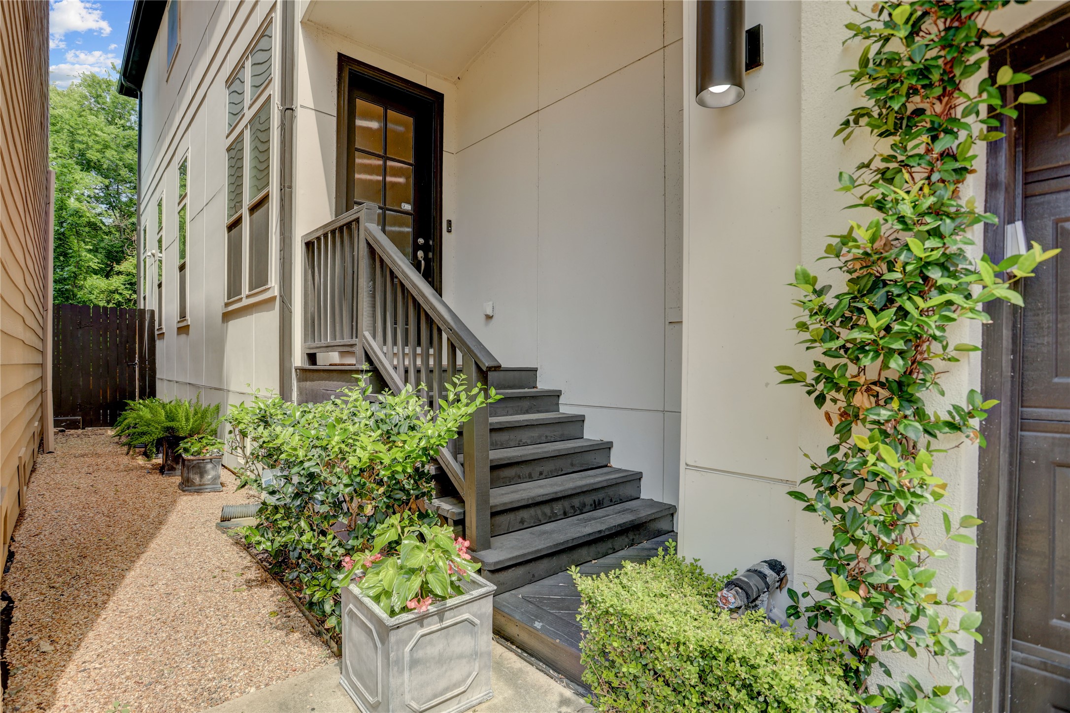 4124 Bonner View Lane Houston, TX 77007 - Photo 5 of 31 Step into elegance with this home, featuring a beautifully landscaped entryway and a charming staircase leading to an welcoming leaded glass front door.
