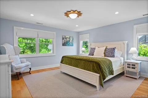 a spacious bedroom with a large bed and a chandelier