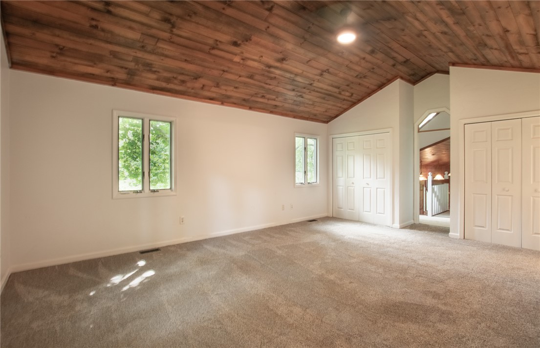 200 Chenault Road Townville, SC 29689 - Photo 23 of 47 A spacious room features a unique wooden vaulted ceiling and soft carpeting.