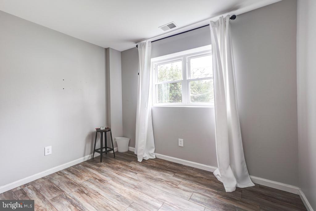 51 Kinsman View Circle Silver Spring, MD 20901 - Photo 17 of 32 an empty room with wooden floor and windows