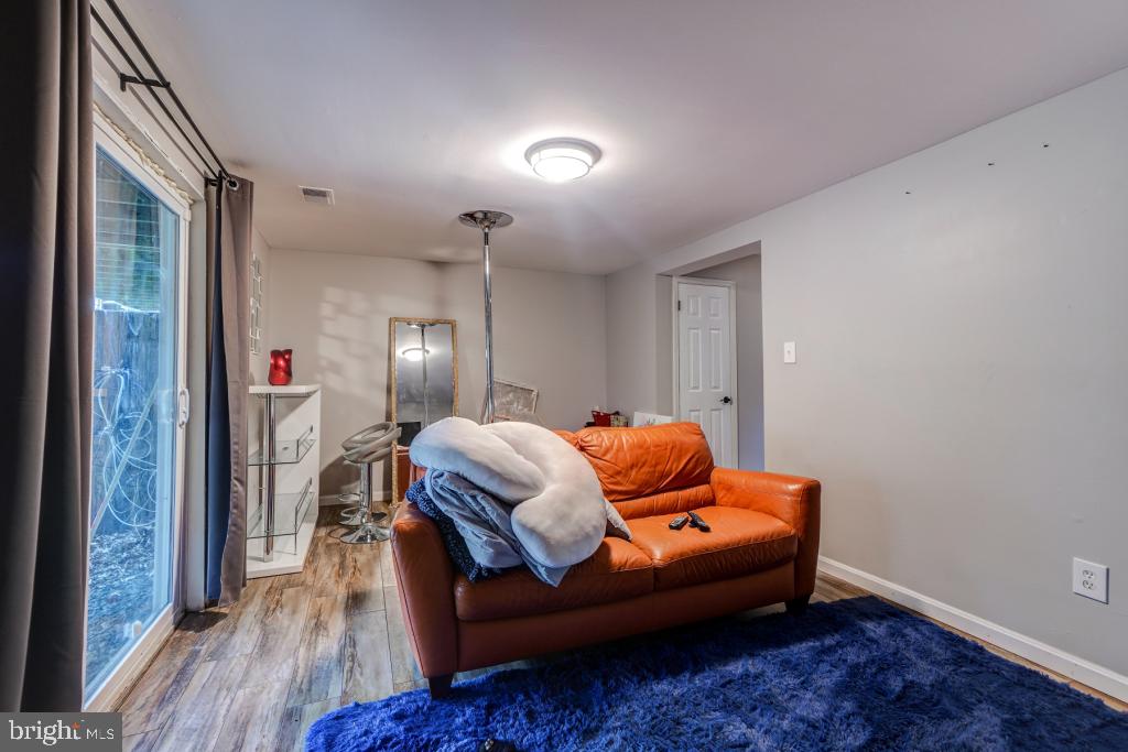 51 Kinsman View Circle Silver Spring, MD 20901 - Photo 21 of 32 a room with furniture and wooden floor