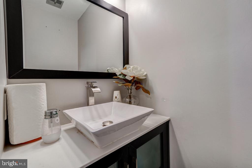 51 Kinsman View Circle Silver Spring, MD 20901 - Photo 4 of 32 a bathroom with a sink and a mirror