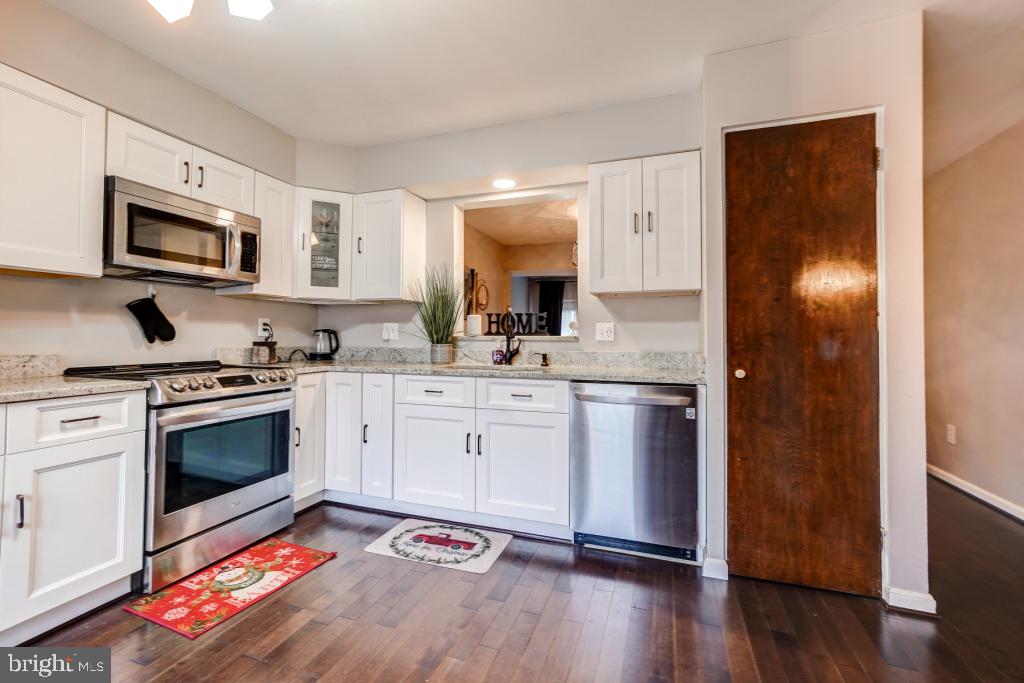 51 Kinsman View Circle Silver Spring, MD 20901 - Photo 6 of 32 a kitchen with stainless steel appliances granite countertop a stove a sink and a microwave