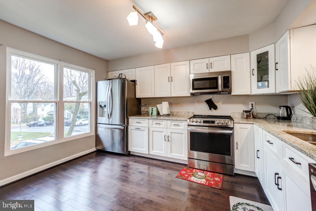 51 Kinsman View Circle Silver Spring, MD 20901 - Photo 8 of 32 a kitchen with granite countertop a refrigerator stove top oven and sink