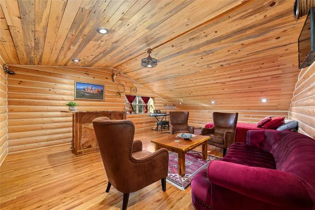 a dining room with furniture and wooden floor