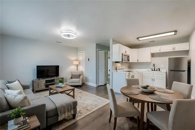 a kitchen with a sink cabinets stainless steel appliances and a window