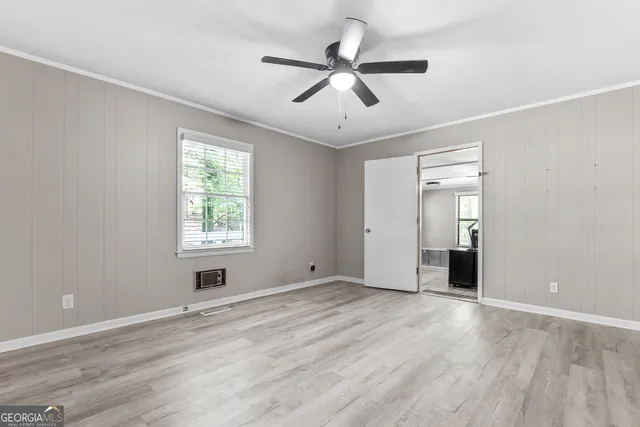 wooden floor in an empty room with a window