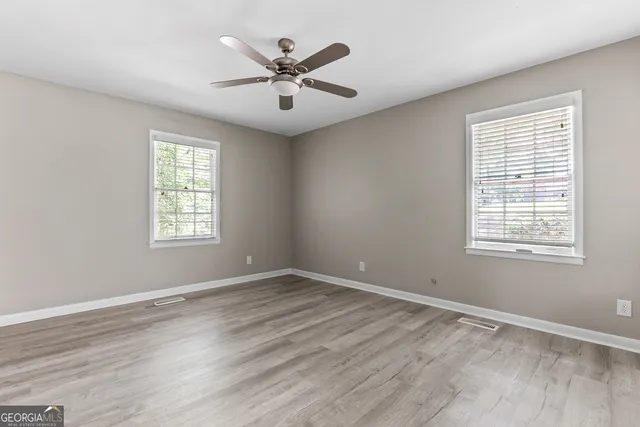 wooden floor in an empty room with a window