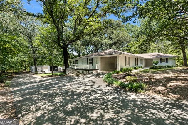 a front view of a house with a garden