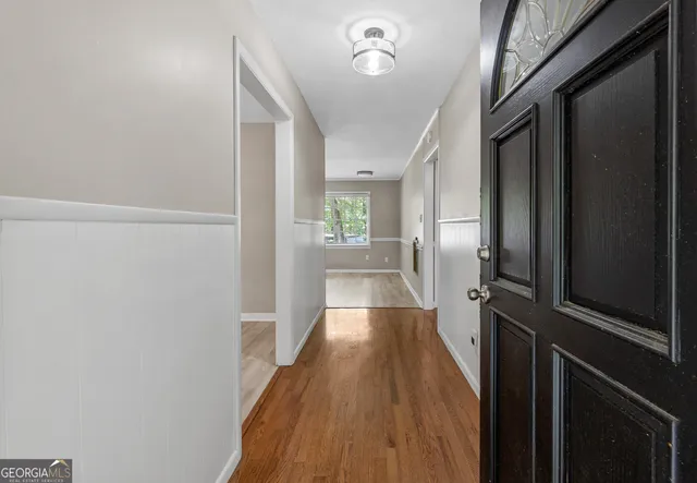 a view of a hallway view with wooden floor and staircase