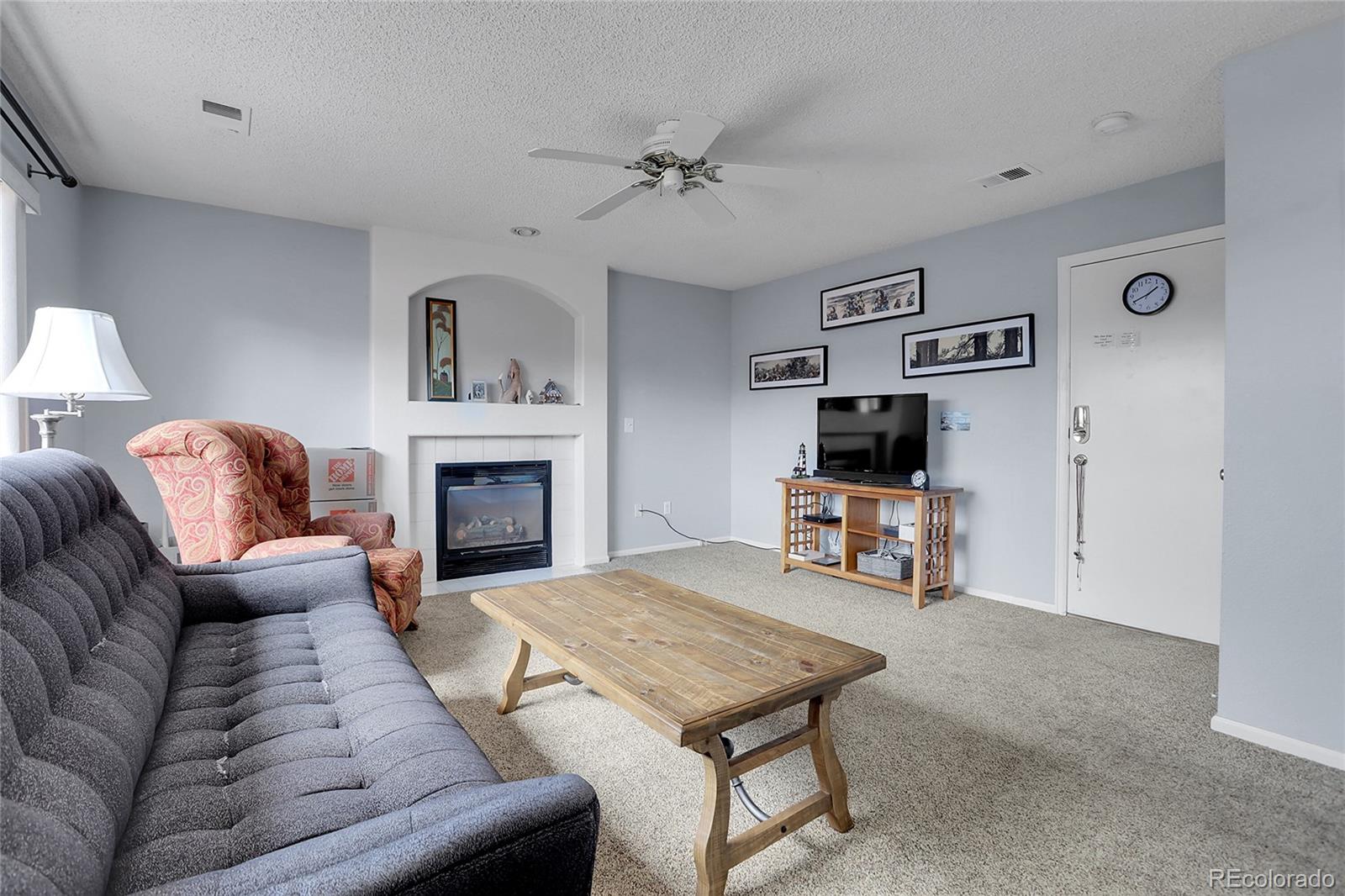 9806 South Castle Ridge Circle Highlands Ranch, CO 80129 - Photo 12 of 36 a living room with furniture and a fireplace