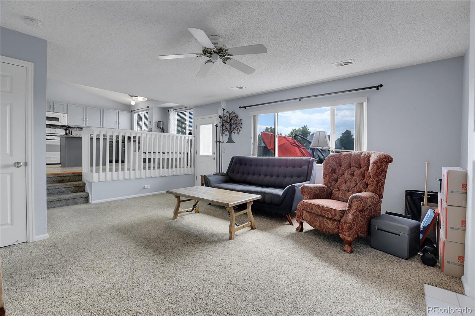 9806 South Castle Ridge Circle Highlands Ranch, CO 80129 - Photo 13 of 36 a living room with furniture and a ceiling fan