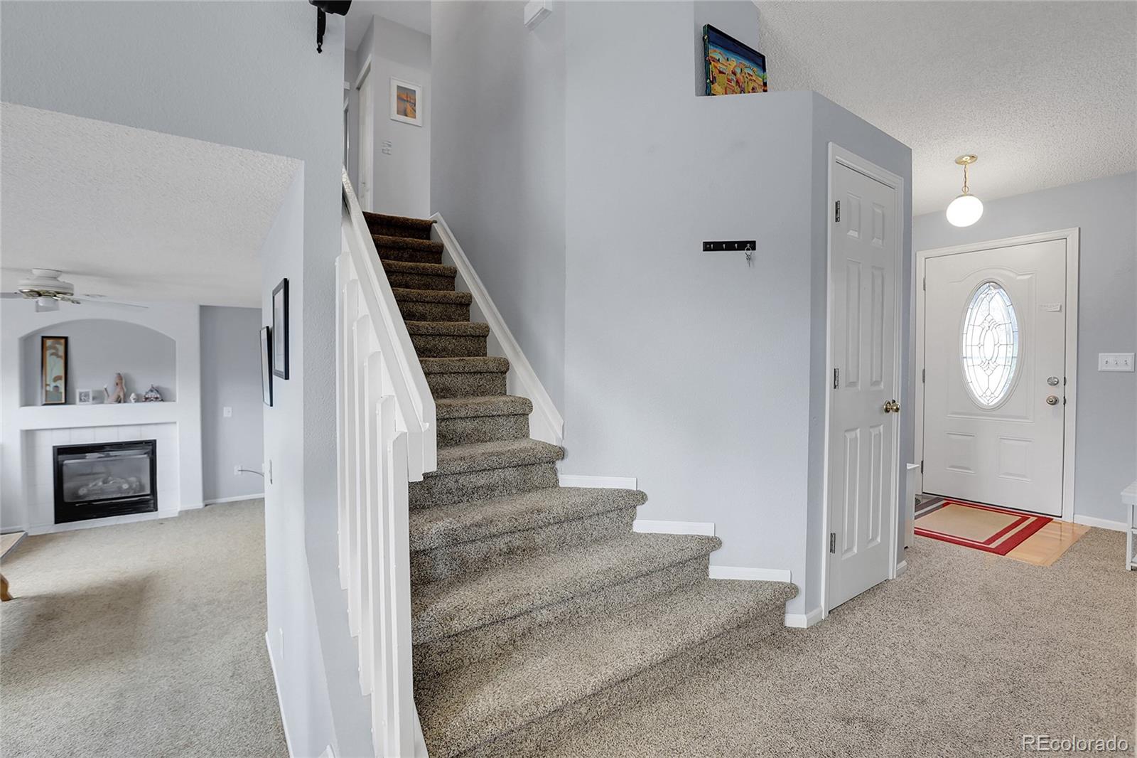9806 South Castle Ridge Circle Highlands Ranch, CO 80129 - Photo 15 of 36 a view of a livingroom with wooden floor and a fireplace