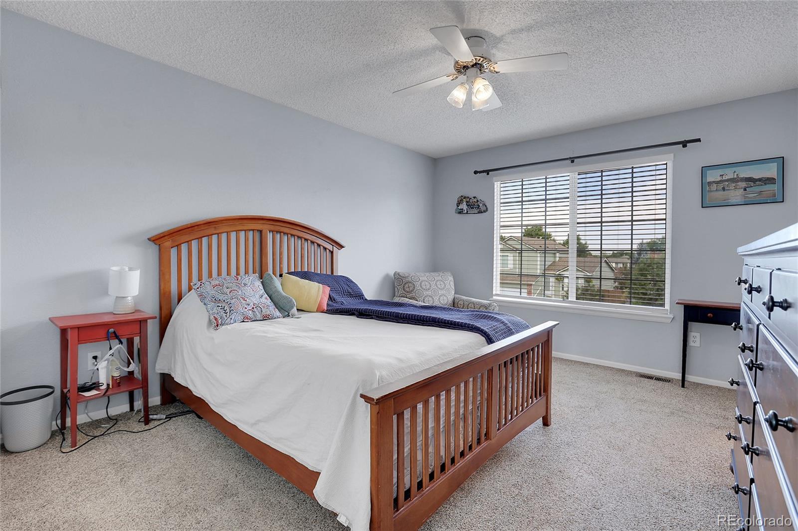 9806 South Castle Ridge Circle Highlands Ranch, CO 80129 - Photo 16 of 36 a bedroom with a bed and a chandelier