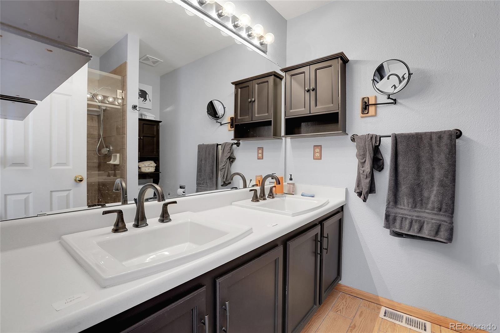 9806 South Castle Ridge Circle Highlands Ranch, CO 80129 - Photo 18 of 36 a kitchen with stainless steel appliances a sink a kitchen island a stove and cabinets