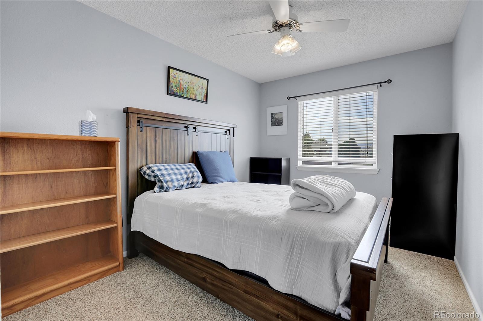 9806 South Castle Ridge Circle Highlands Ranch, CO 80129 - Photo 22 of 36 a bedroom with a bed and a window