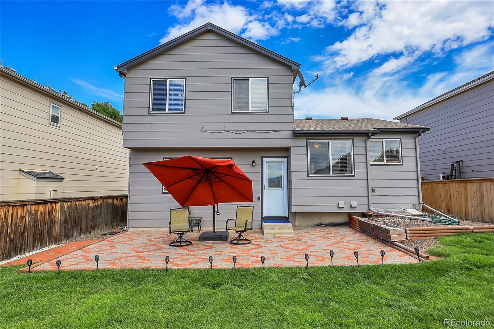 9806 South Castle Ridge Circle Highlands Ranch, CO 80129 - Photo 27 of 36 a view of backyard of house with wooden deck and outdoor seating
