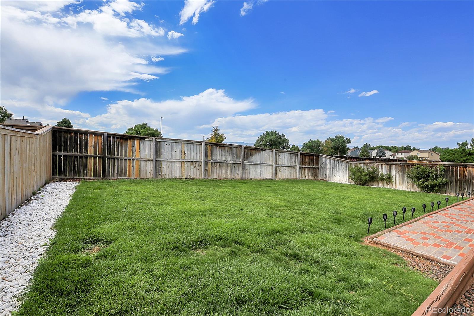 9806 South Castle Ridge Circle Highlands Ranch, CO 80129 - Photo 29 of 36 a view of a backyard with a garden