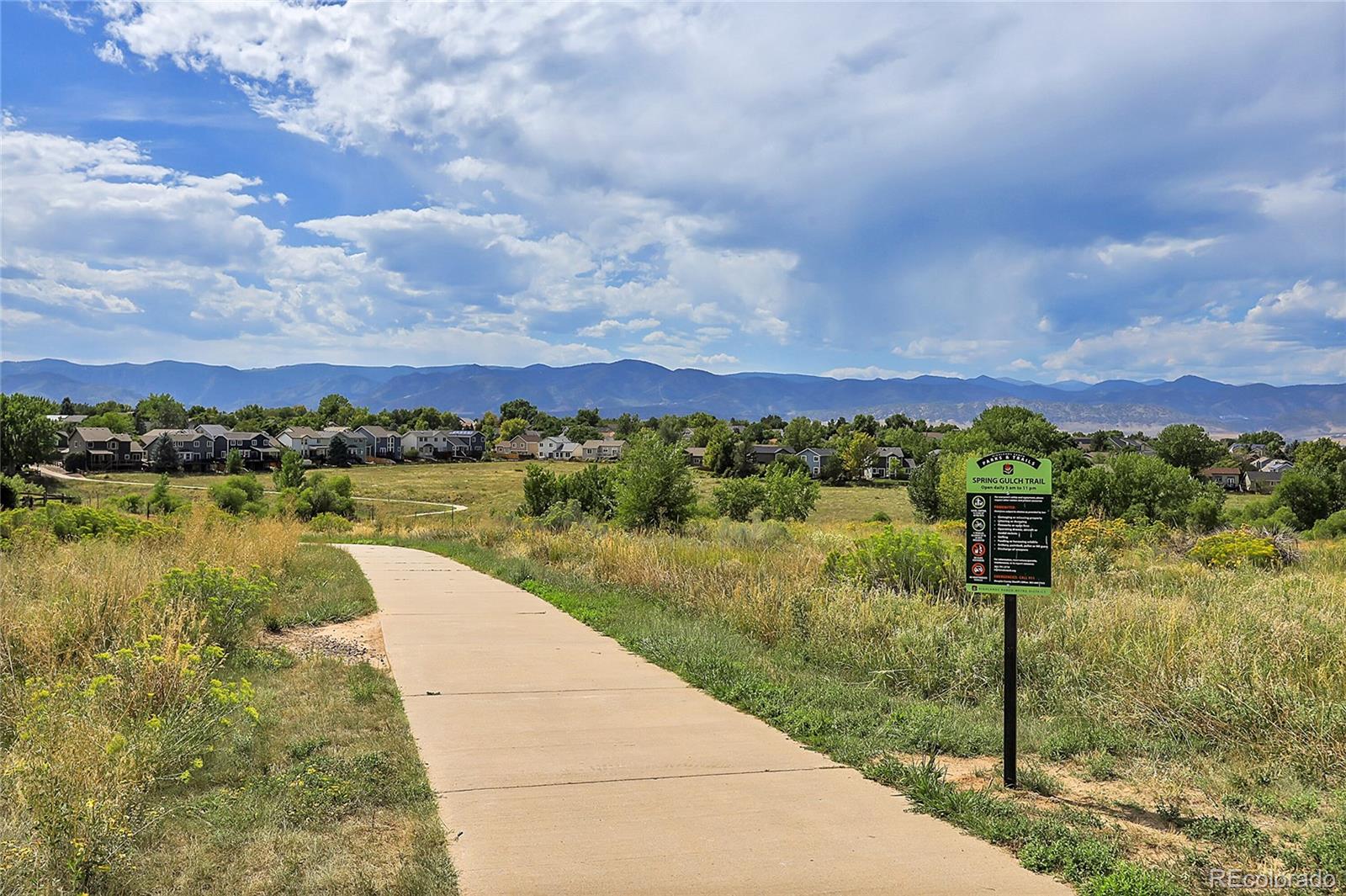 9806 South Castle Ridge Circle Highlands Ranch, CO 80129 - Photo 36 of 36 a view of a lake with a houses in the back