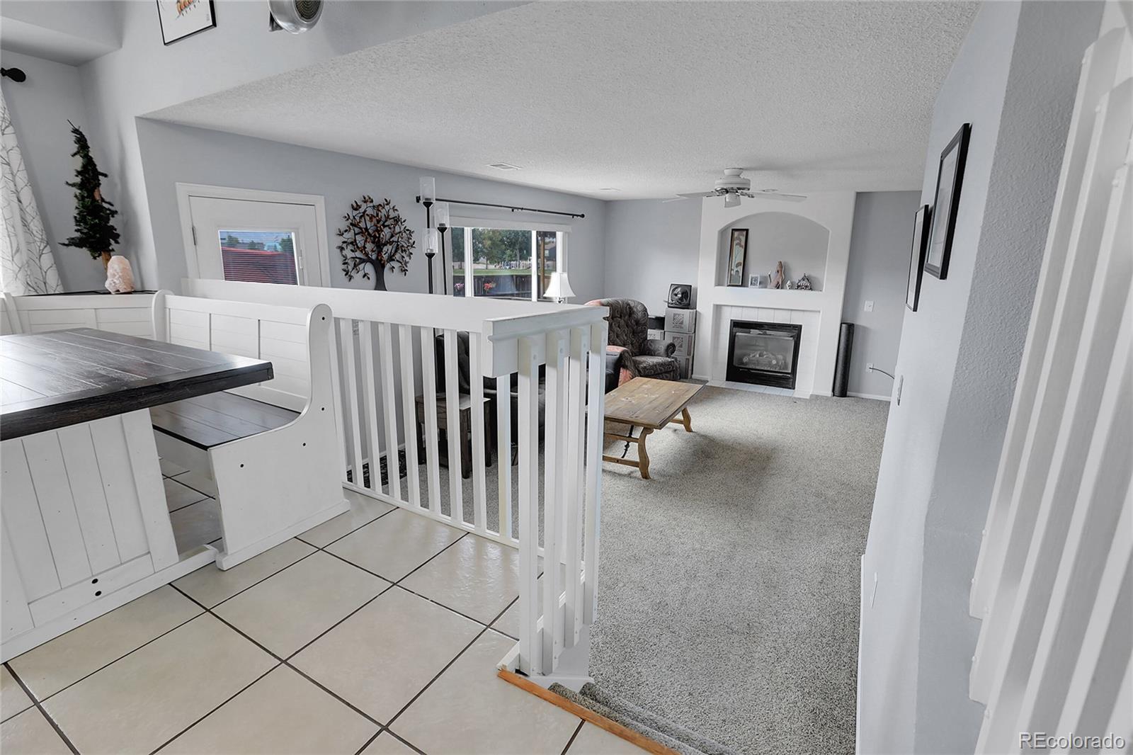 9806 South Castle Ridge Circle Highlands Ranch, CO 80129 - Photo 10 of 36 a living room with furniture and a fireplace